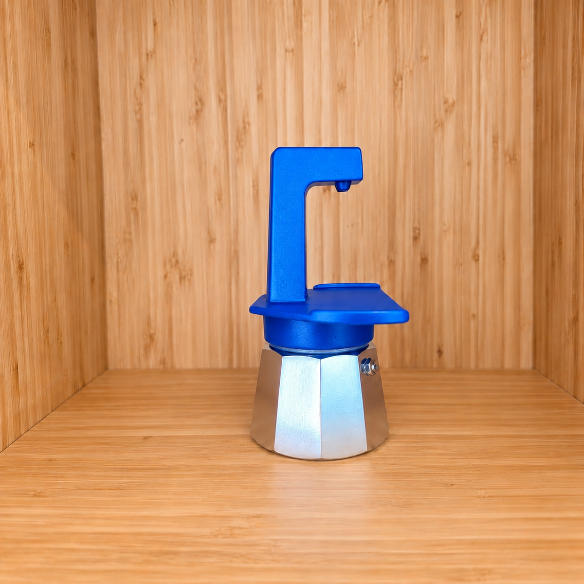 A blue Gemini Express Moka pot sideview on a light wood grain surface against a matching wood grain background.