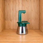 A Green Gemini Express espresso moka pot sideview on a wooden surface against a wooden wall background.