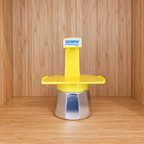 A Yellow Gemini Express espresso moka pot centered on a wooden surface against a wooden wall background.